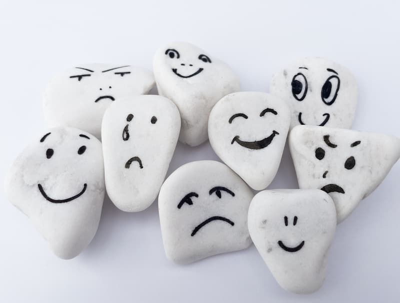 Emotionale Kompetenzen im Beruf: Bedeutung & Vorteile 1 Mehrere Steine mit aufgemalten Gesichtern, was ist emotionale Kompetenz im Beruf?